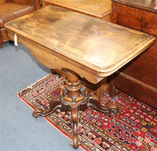 A Victorian rosewood folding-top card table on carved column and quadripartite base W.92cm